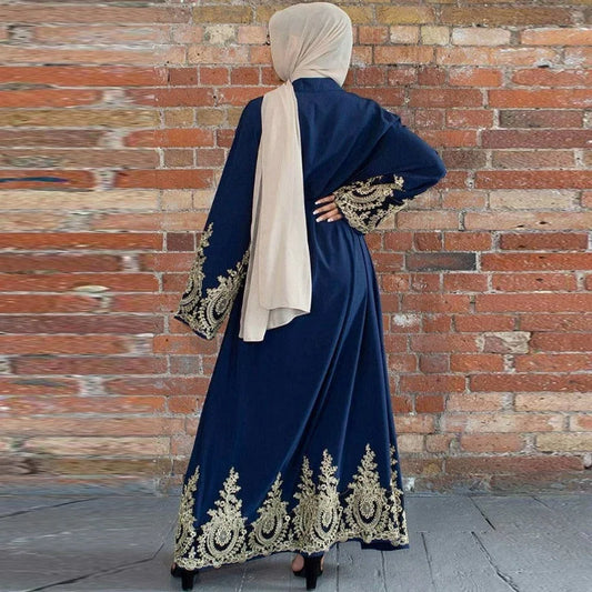 Navy blue velvet abaya with gold embroidery paired with a beige hijab for elegant modest wear