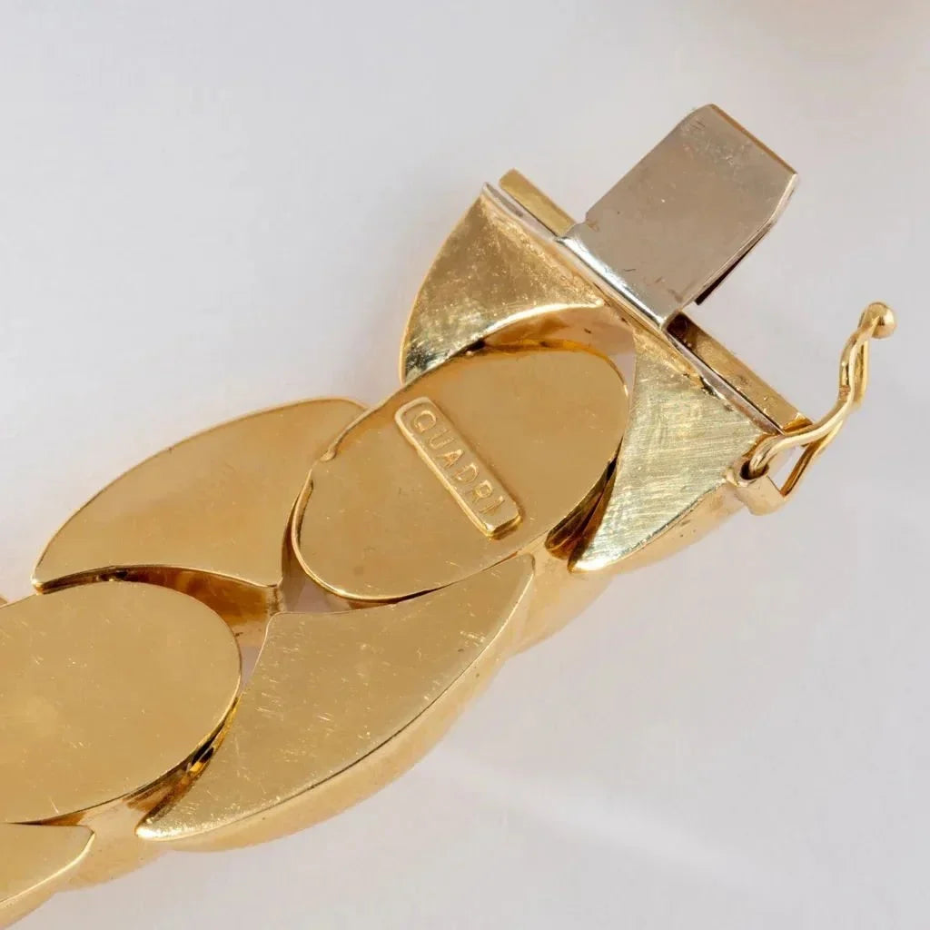 Gold chain link bracelet with textured clasp and logo for Leisure Tapis Chien Teckel