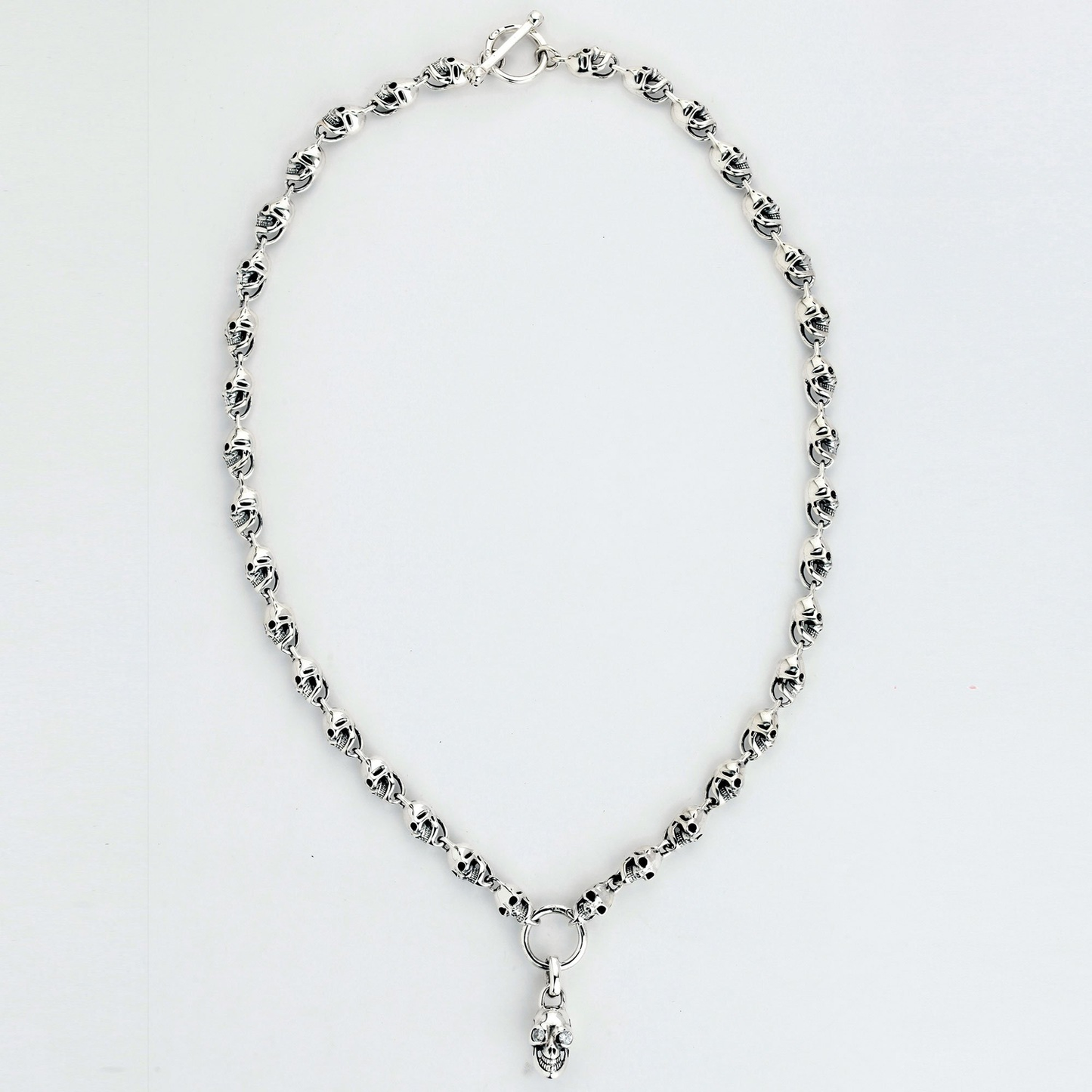 Silver skull anklet with dangling charm from PNG Product for edgy jewelry style