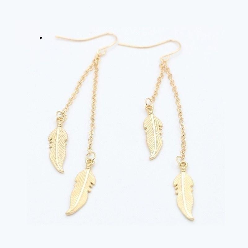 Gold feather drop earrings with chain links, delicate and elegant jewelry design