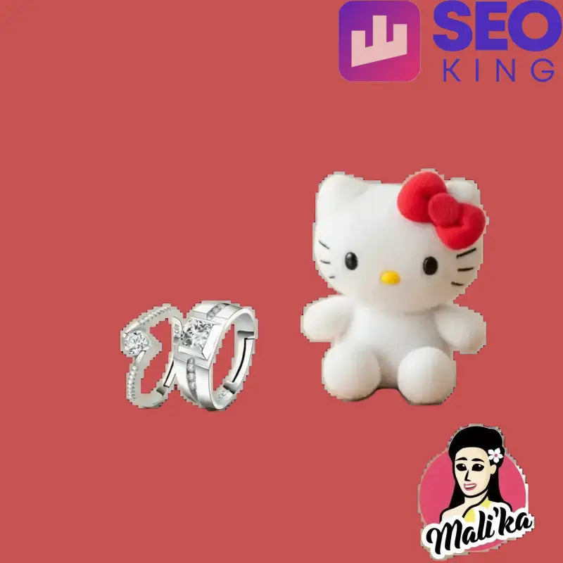 Silver rings with clear stones next to a white Hello Kitty plush toy with a red bow