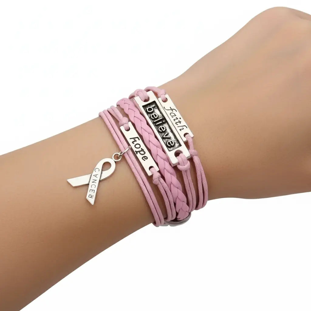 Pink leather wrap bracelet with faith and believe charms, bow tie, and breast cancer ribbon