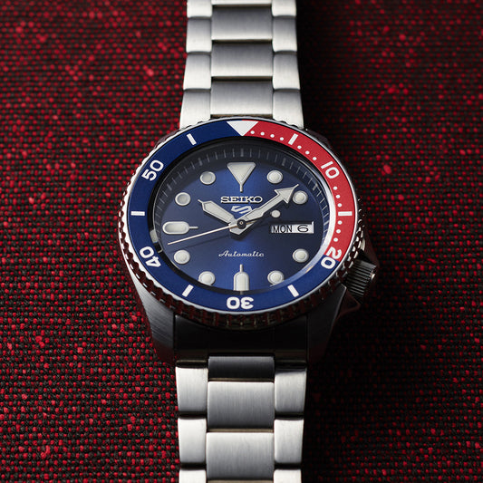 SEIKO SRPD53 watch with a red and blue dial on a sleek display