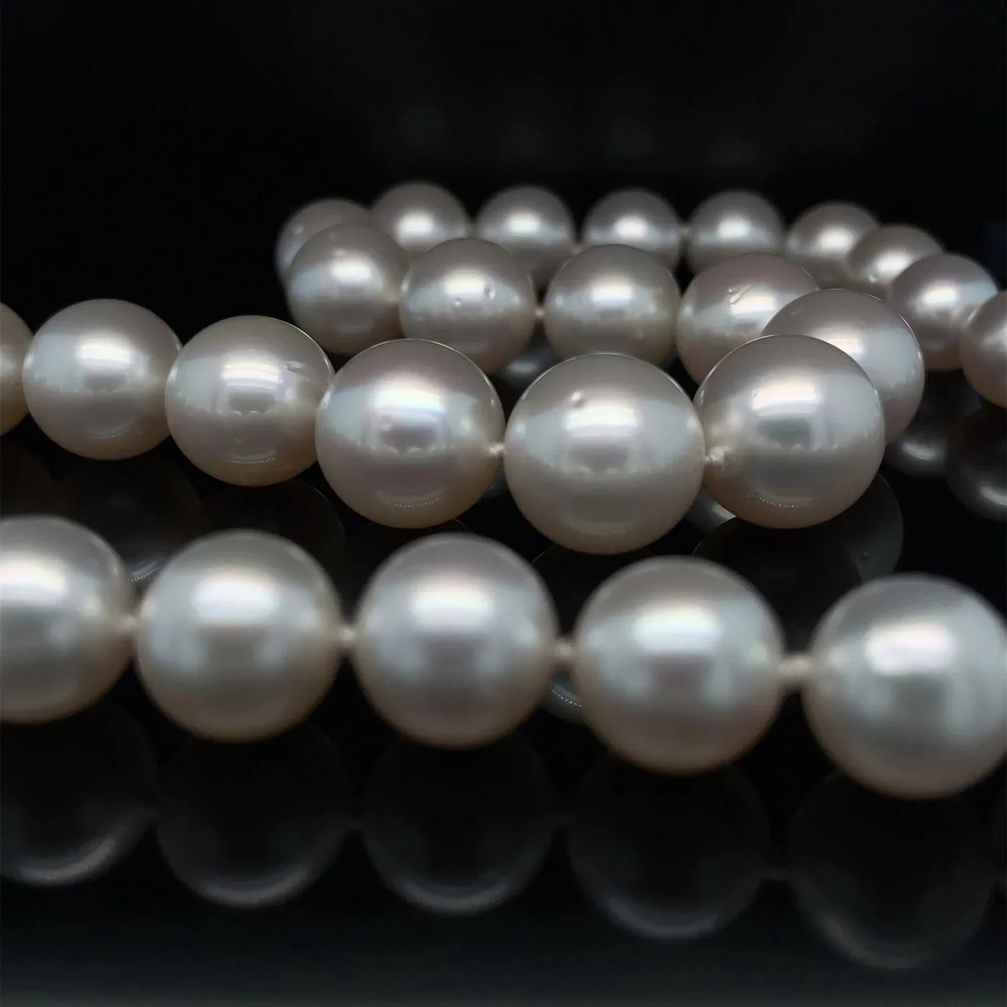 Pearl necklace with smooth lustrous white pearls on dark background for a a a a Tes product