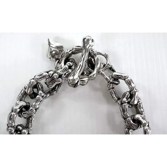 Silver skull chain link bracelet from Bali displayed on a jewelry stand
