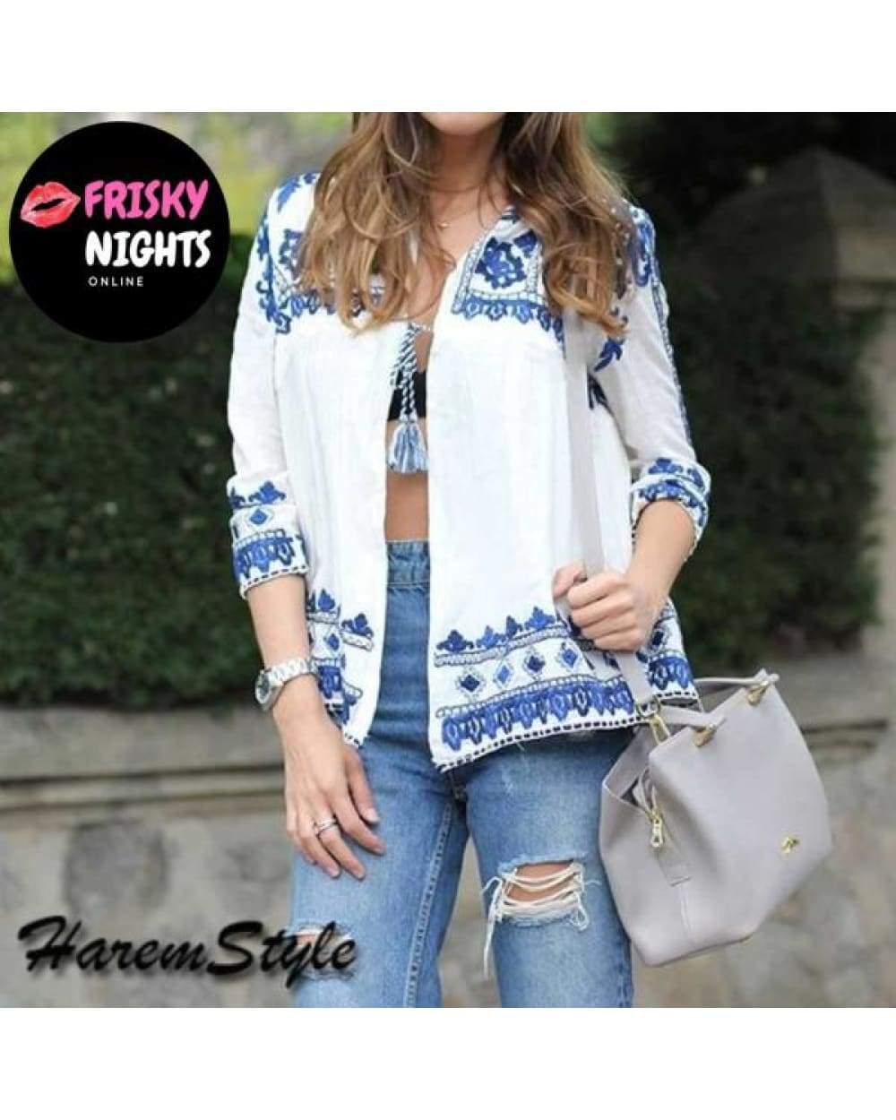 White and blue embroidered blouse with tassels paired with denim jeans and a gray purse