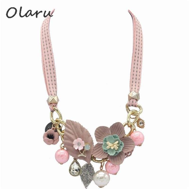 Pastel floral charm necklace with pink and white beads, silver accents, and fabric strap