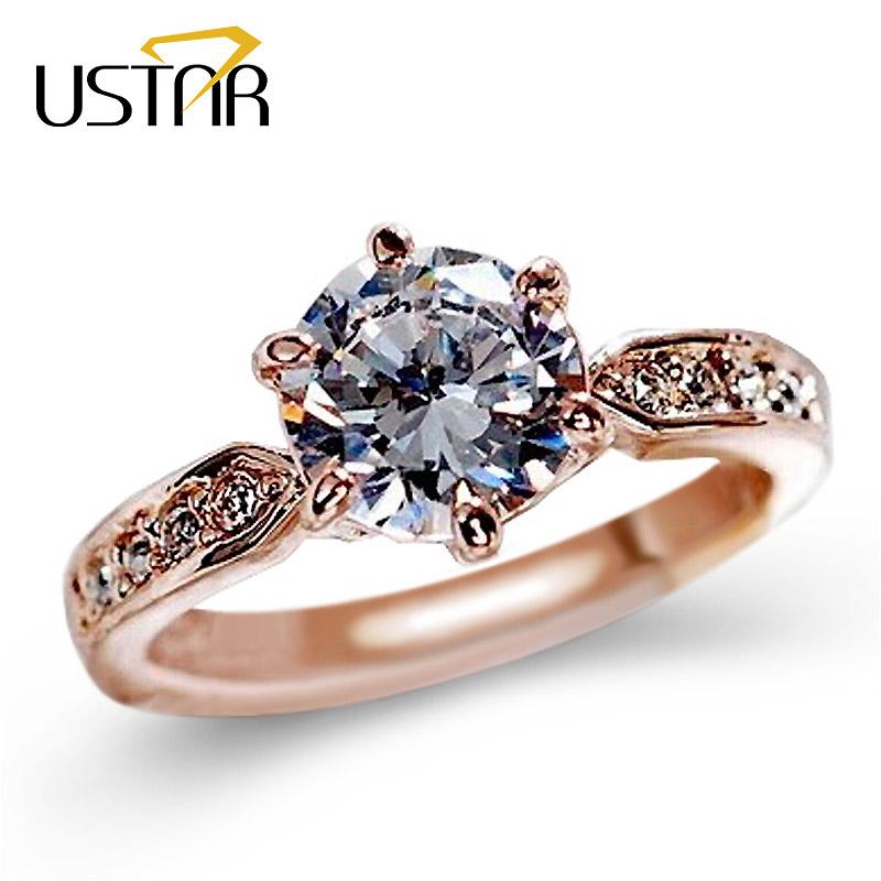 Rose gold engagement ring with large central diamond and floral band detailing in Zip Product
