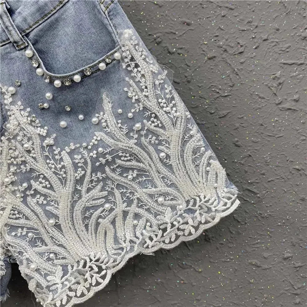 Light wash blue denim shorts with floral embroidery and pearl accents from 501 501 Denim Fashion Cap