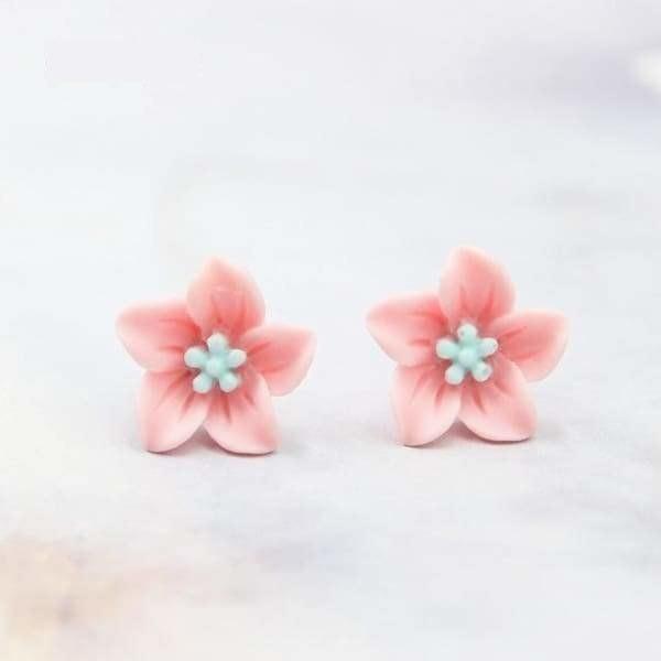 Pink flower stud earrings with light blue centers and white beads made of polymer clay