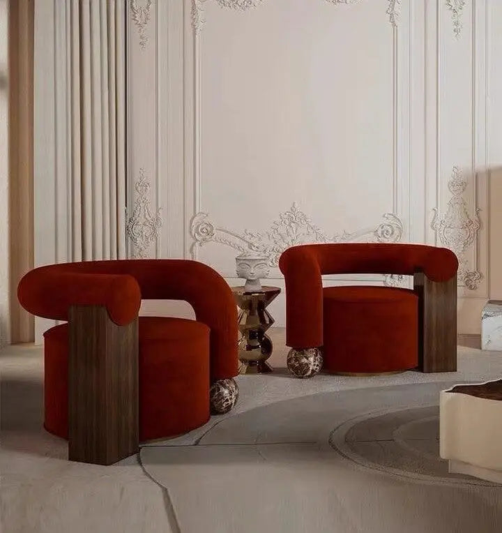 Two deep red velvet armchairs with dark wood frames and marble legs in a meta title test skip collection.