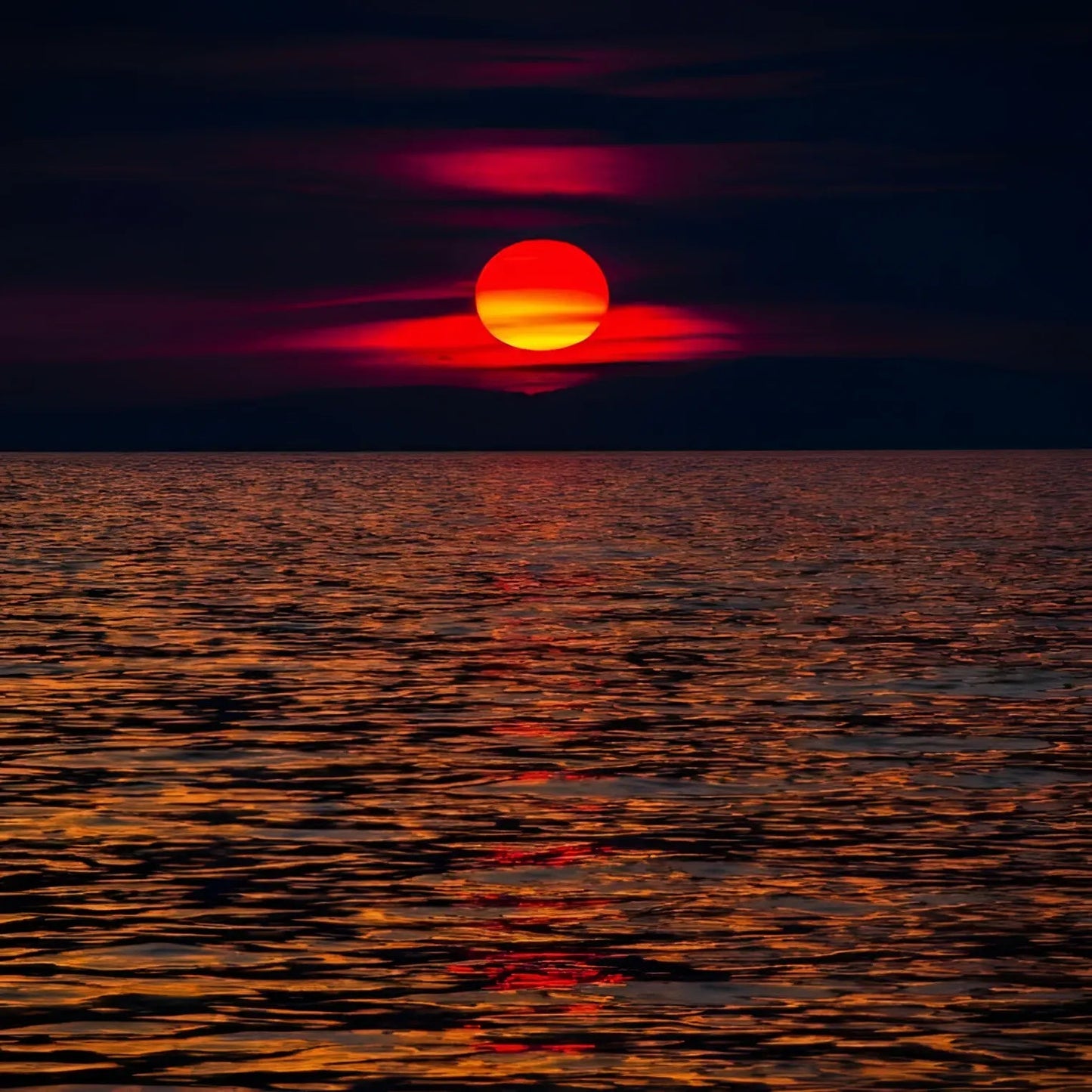 A vibrant orange-red sunset over dark ocean reflecting fiery light in pink heart bagels valentine’s day heart bagels test
