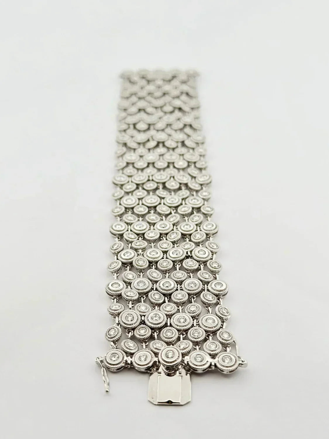Silver-toned diamond bracelet with multi-row round-cut stones and intricate metalwork featured in 501 denim fashion cap product
