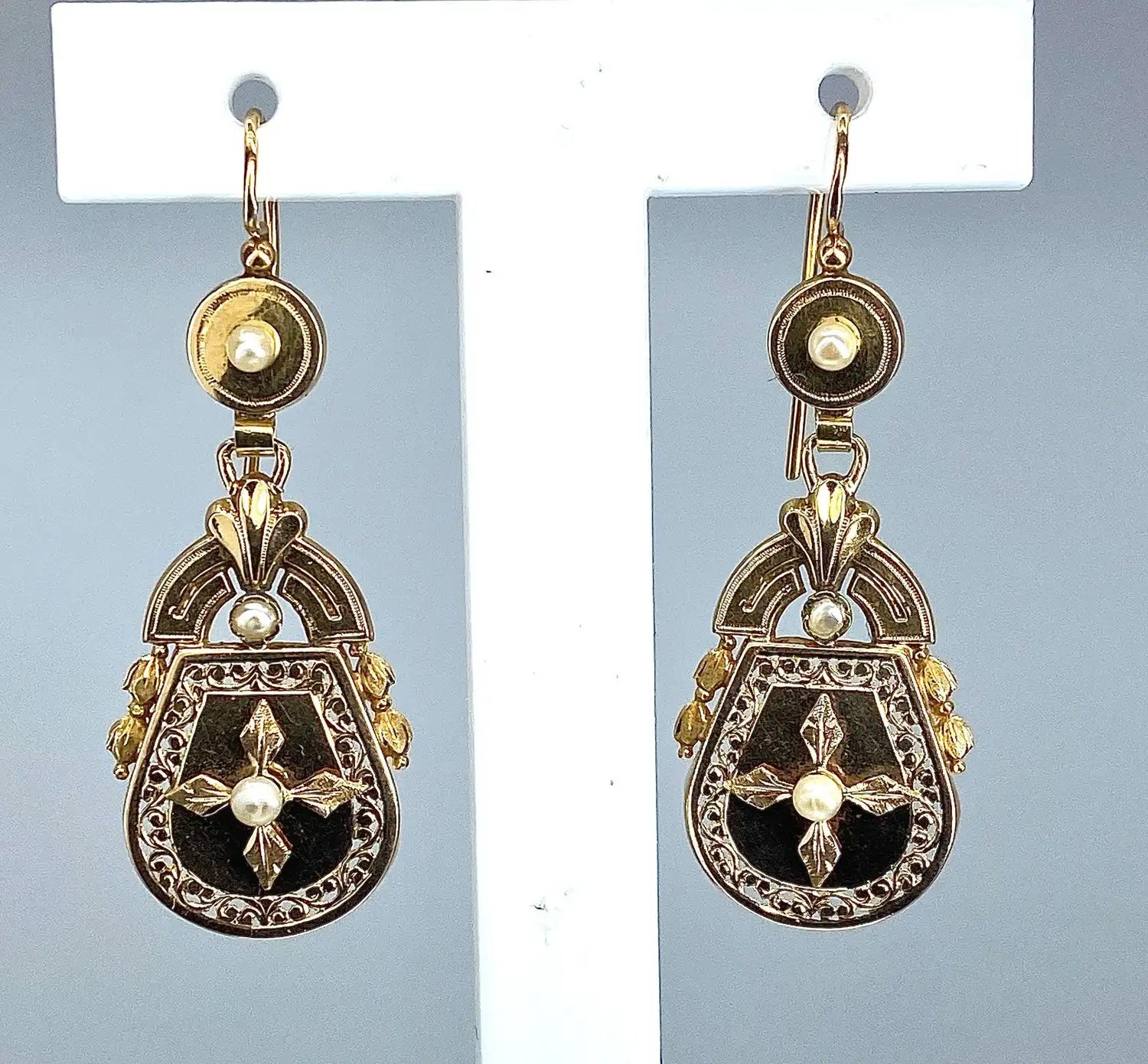 Antique-style gold and black enamel drop earrings with filigree, central pearl, leaf motifs, and smaller pearl accents from 501 denim fashion cap collection