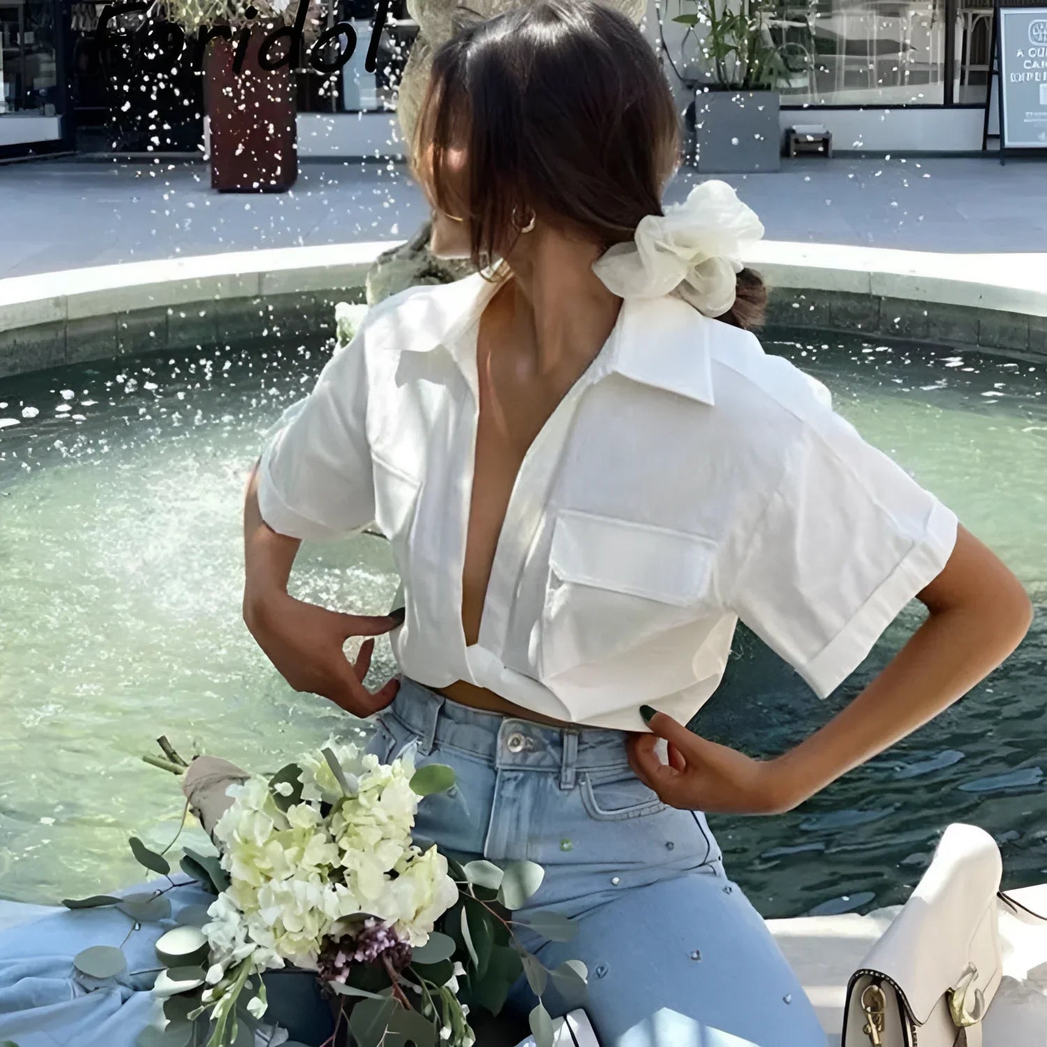 White bow hair accessory with pearl embellishments for elegant hair styling