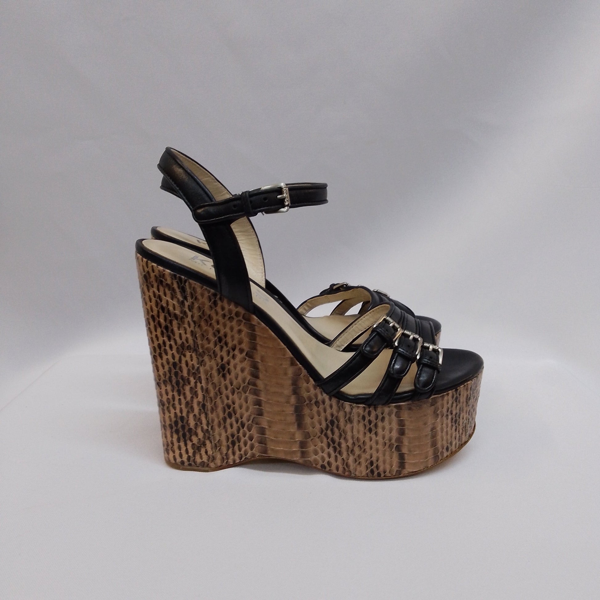 Snake skin wedge sandal with black straps, buckle, and brown platform heel for sale