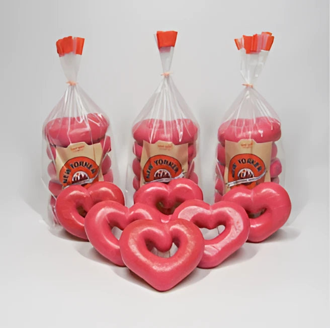Bright pink heart bagels in clear bags with orange caps branded new yorker bagels for valentine’s day heart bagels test