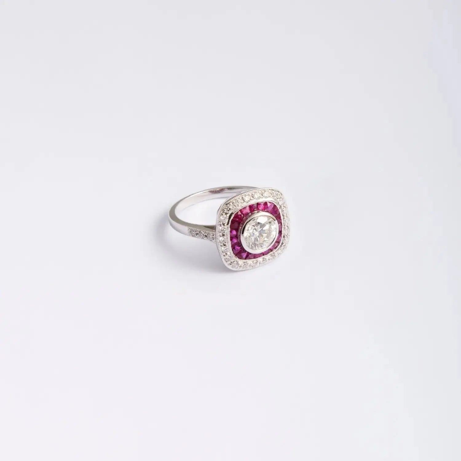 High resolution silver ring with diamond and pink rubies in cushion halo setting.