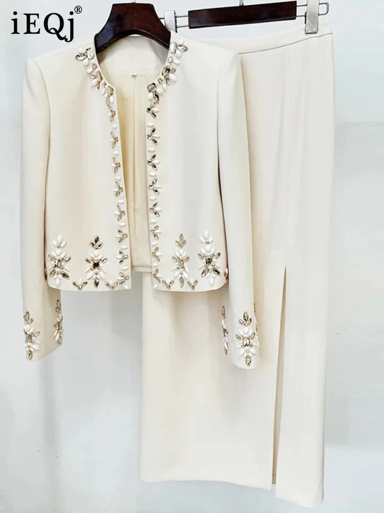 Cream-colored embroidered Bali suit with floral patterns and ruffled edges