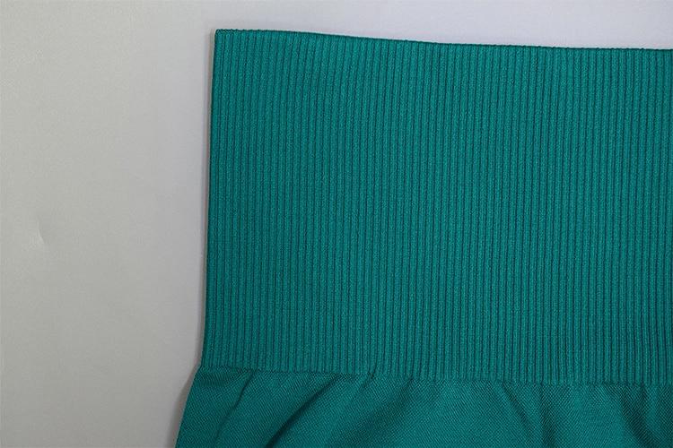 Teal ribbed fabric sweater with ruffled hem displayed in Test BG Photos