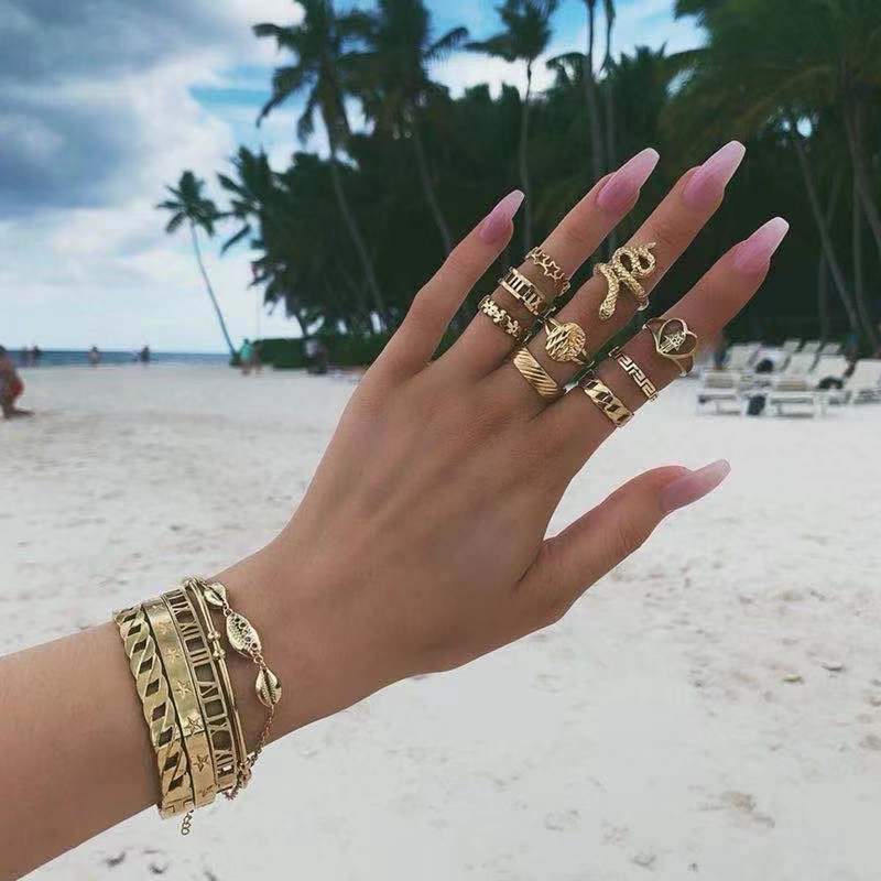 Gold leaf patterned bangle bracelet with multiple rings displayed in Test BG Photos