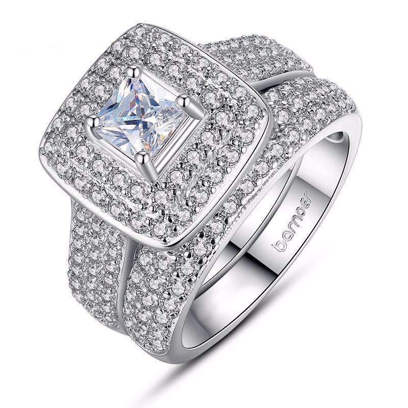 Silver diamond engagement ring with princess cut center stone and pave halo on Zip Product