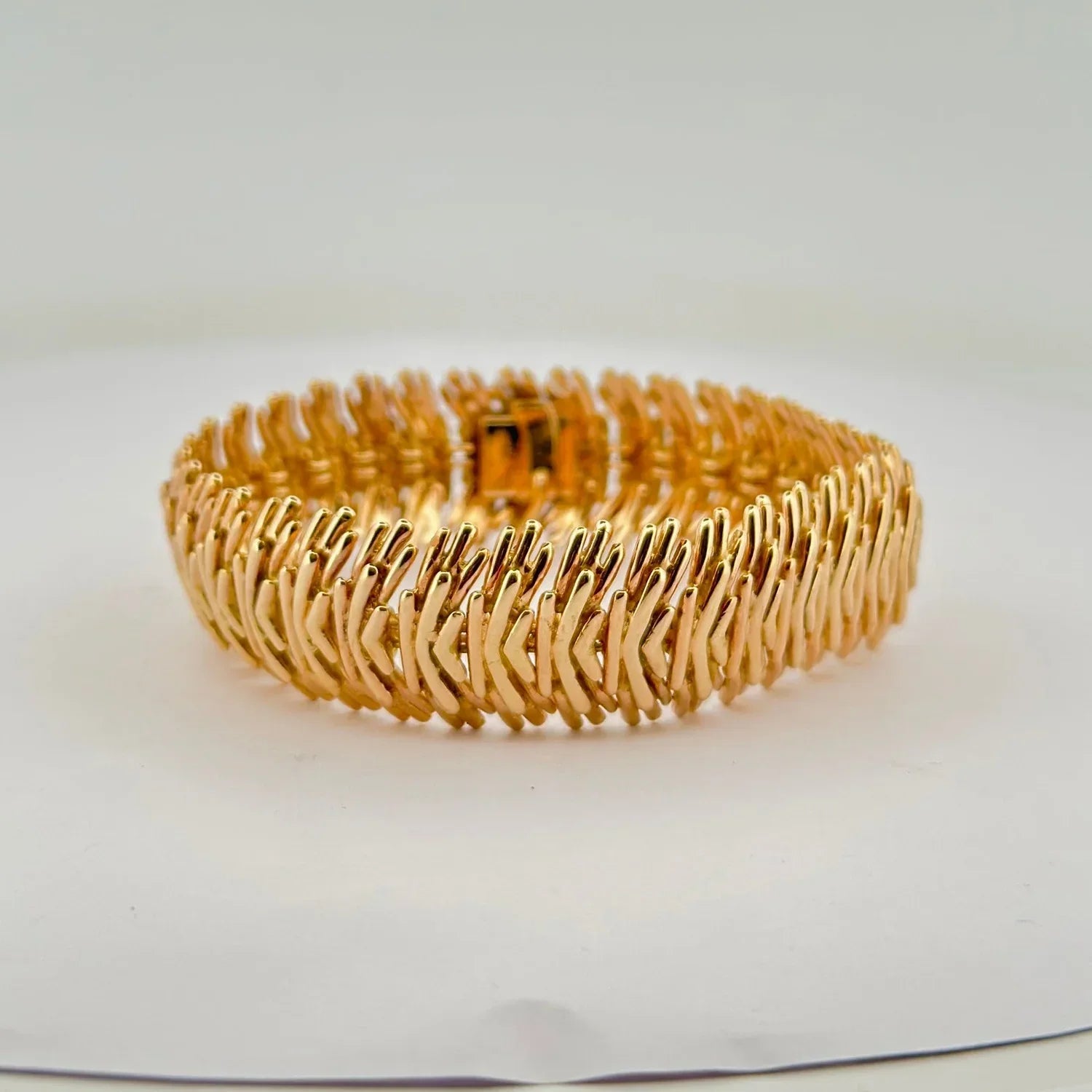 Gold textured bangle bracelet with clasp closure for stylish clothing accessories