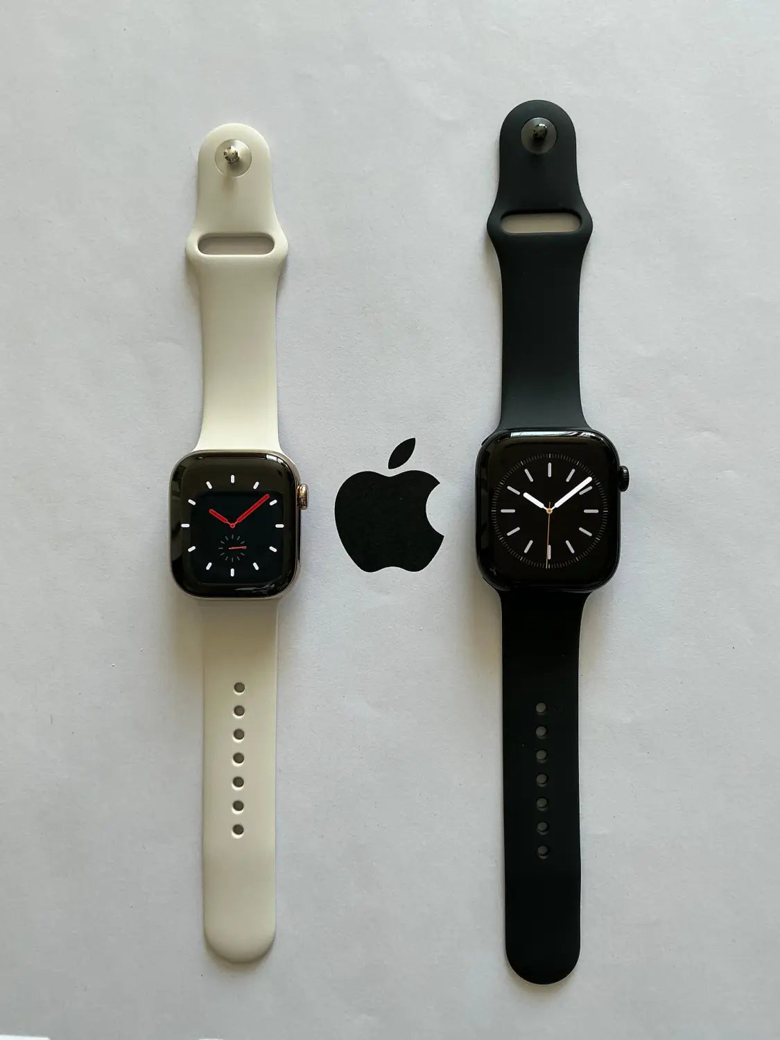Two Apple Watch models: white and black silicone bands, watermark gif test