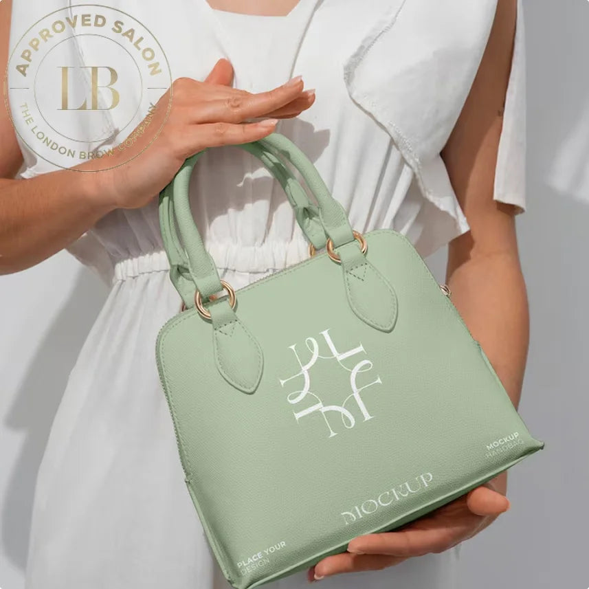 Mint green vegan leather tote bag with monogram design and gold hardware